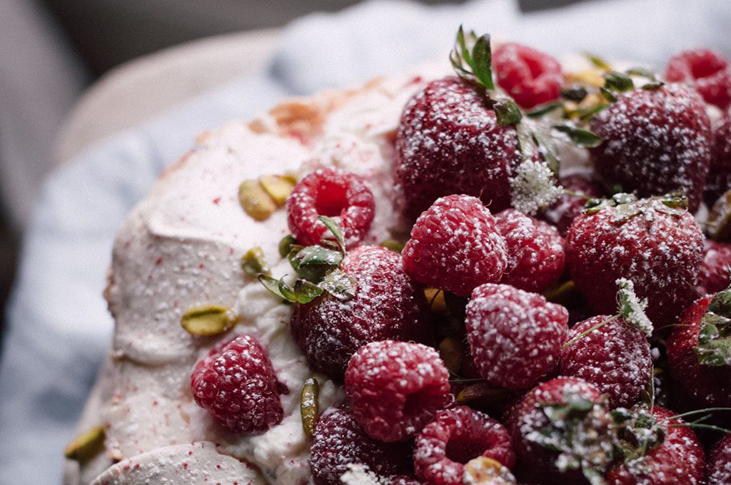 White christmas cake, with raspberries on top
